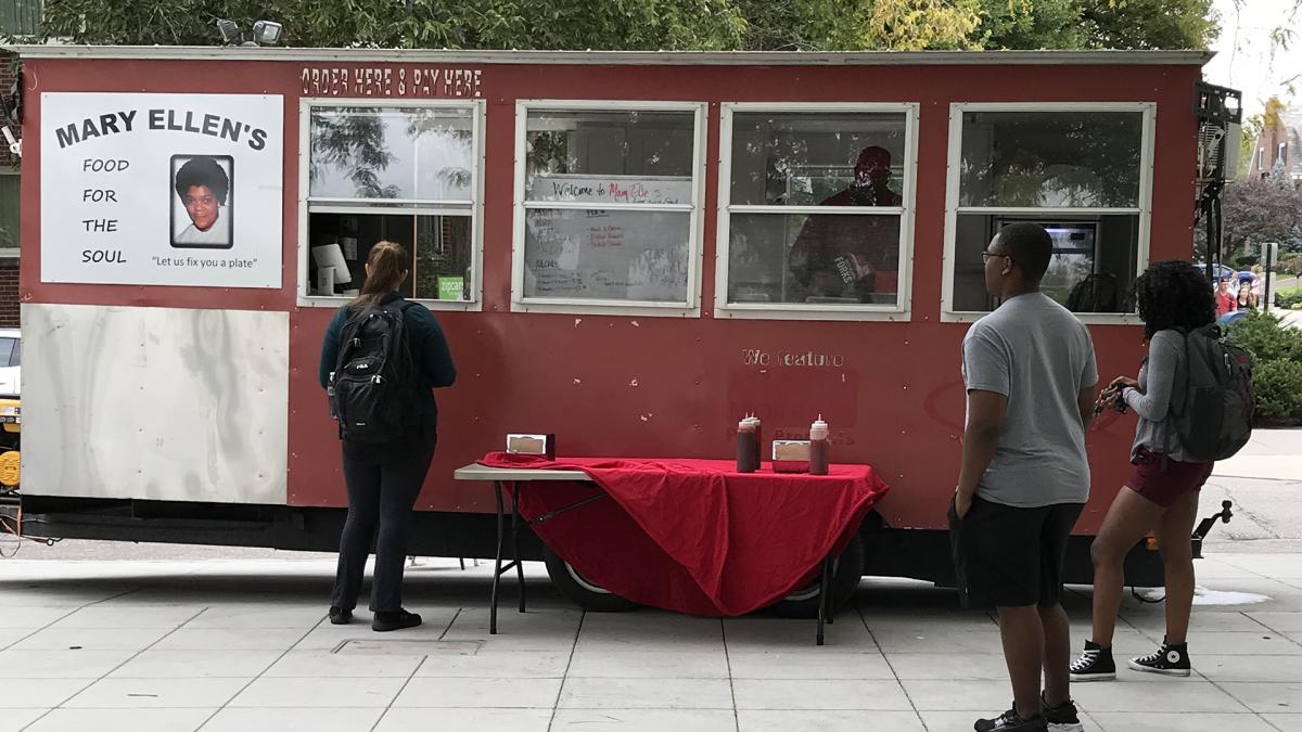 Students wait in line to order from a food truck